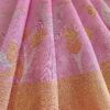 Fabric shot of Pastel pink matka silk jamdani saree flamingo motifs